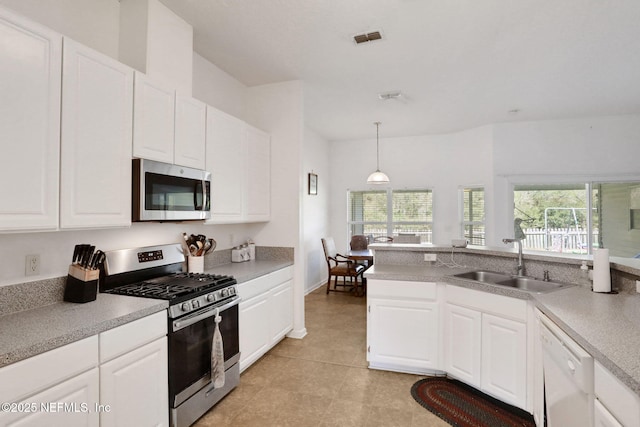 kitchen with visible vents, a sink, stainless steel appliances, light countertops, and white cabinetry