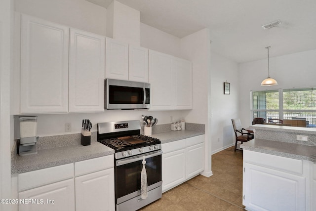 kitchen featuring visible vents, white cabinets, and stainless steel appliances