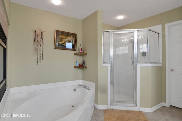 full bath featuring tile patterned flooring, a shower stall, a bath, and a textured ceiling