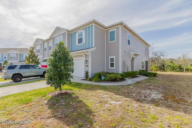 multi unit property featuring concrete driveway and a garage