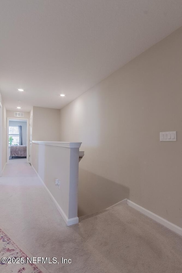 hallway featuring visible vents, an upstairs landing, light carpet, recessed lighting, and baseboards