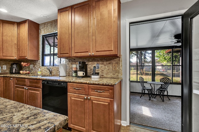 kitchen featuring a sink, backsplash, dishwasher, and a textured ceiling