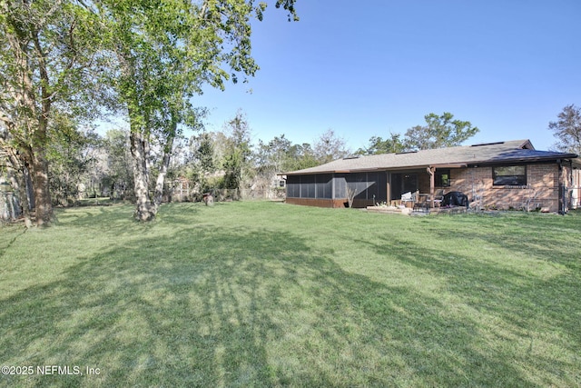 view of yard featuring a sunroom