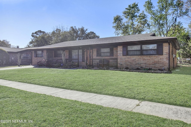 single story home featuring a front lawn and brick siding