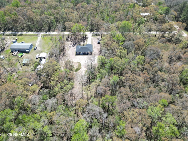 bird's eye view featuring a wooded view