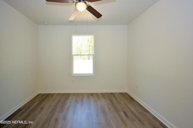 unfurnished room featuring wood finished floors, baseboards, and ceiling fan