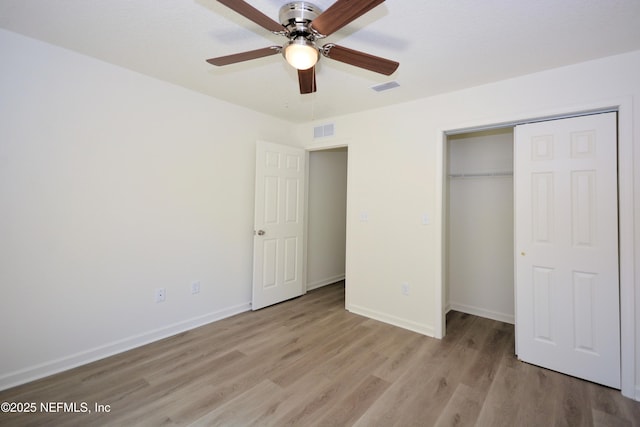 unfurnished bedroom with visible vents, baseboards, and light wood-style floors