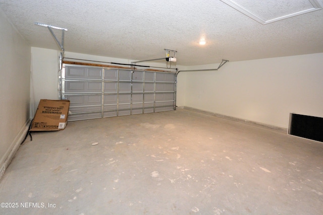 garage with a garage door opener and baseboards