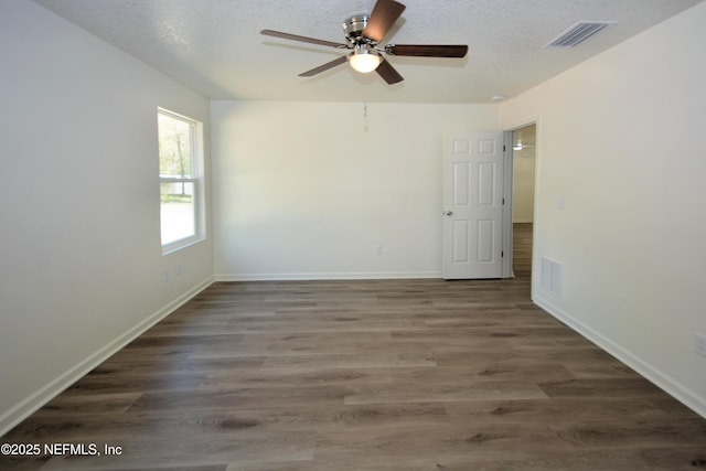 unfurnished room with visible vents, a textured ceiling, and ceiling fan