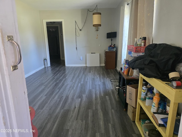 interior space featuring wood finished floors and baseboards