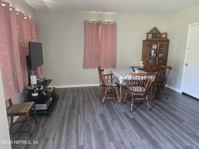 dining area featuring baseboards and wood finished floors