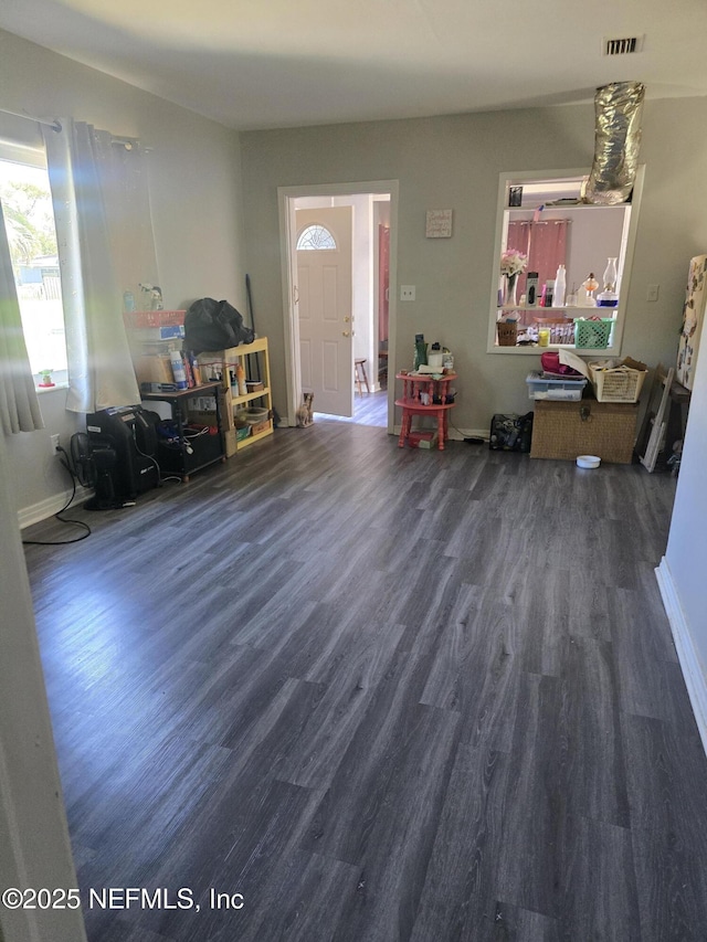 entrance foyer featuring visible vents, baseboards, and wood finished floors