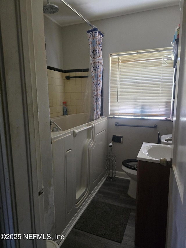 bathroom with vanity, shower / bathtub combination with curtain, toilet, and wood finished floors