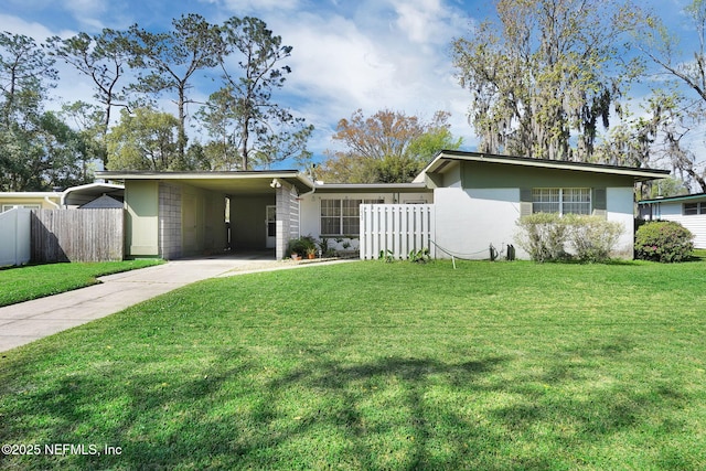 mid-century home featuring a carport, a front lawn, and fence