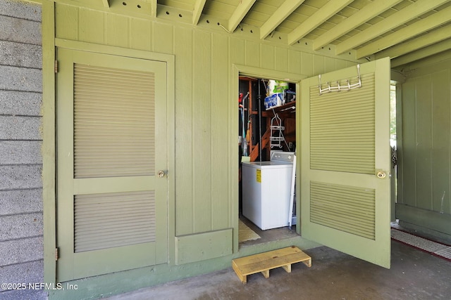 doorway to property featuring washer / dryer