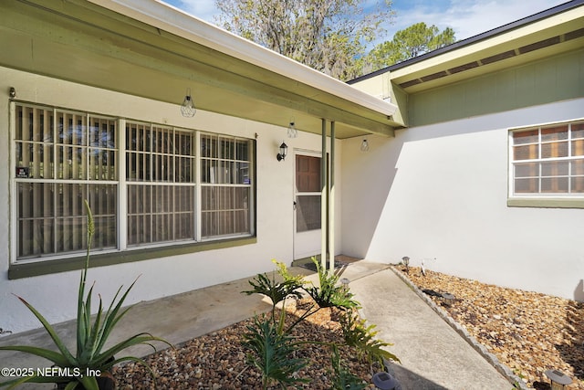 doorway to property with stucco siding