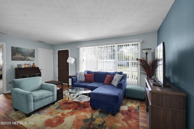 living area featuring a textured ceiling and wood finished floors