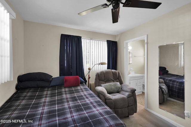 carpeted bedroom featuring a ceiling fan and ensuite bathroom