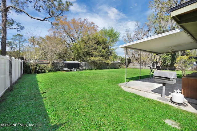 view of yard featuring ceiling fan, a fenced backyard, and a patio area