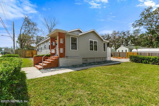 exterior space featuring crawl space, a lawn, and fence