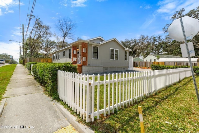 view of front of property with crawl space and a fenced front yard