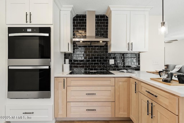 kitchen featuring black appliances, wall chimney exhaust hood, backsplash, and light brown cabinetry