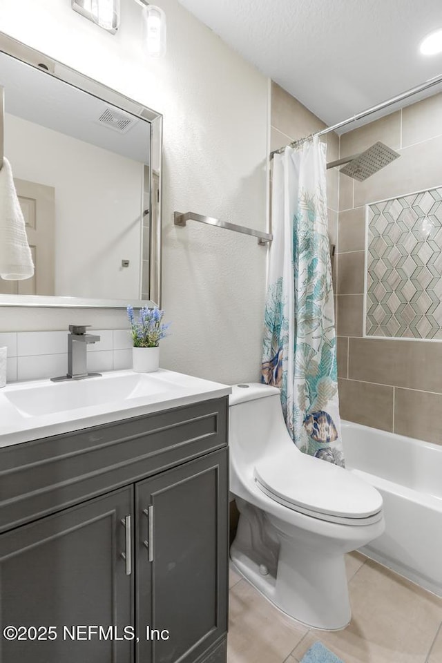 full bathroom with tile patterned floors, visible vents, toilet, shower / tub combo with curtain, and vanity