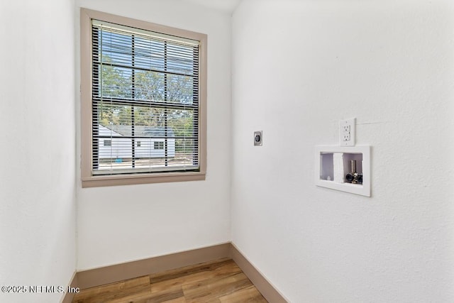 unfurnished room with light wood-type flooring and baseboards