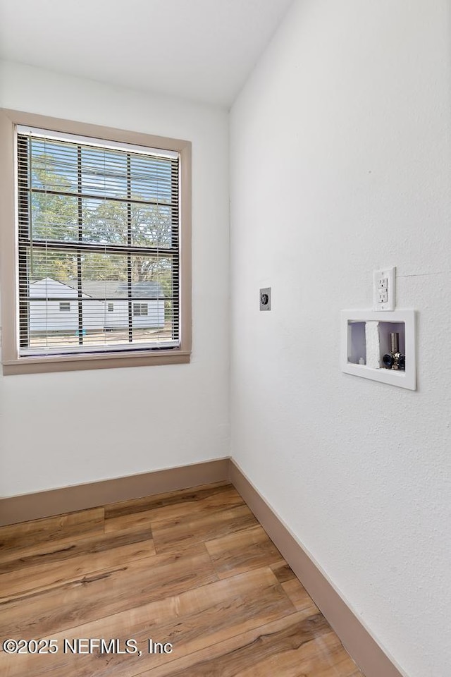 unfurnished room featuring light wood-type flooring and baseboards