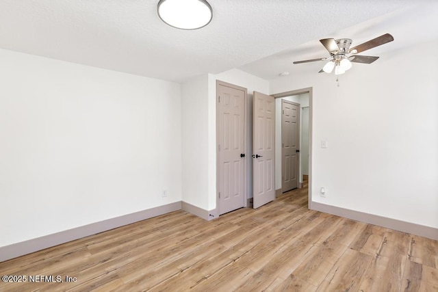 unfurnished bedroom featuring a closet, baseboards, and light wood-style floors