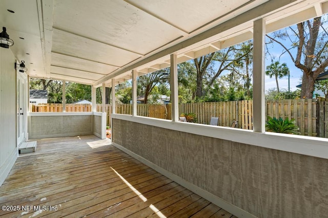 wooden terrace featuring a fenced backyard