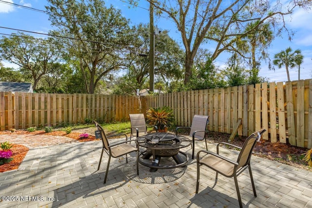 view of patio featuring a fire pit and a fenced backyard