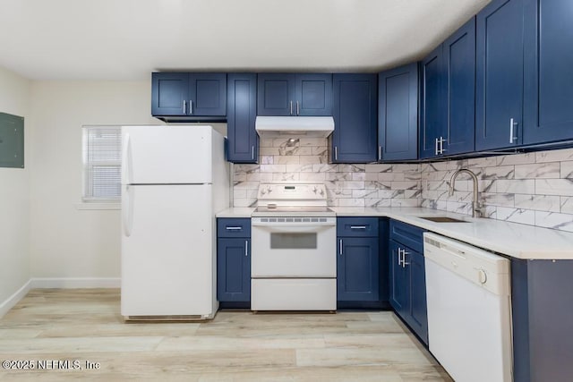 kitchen featuring white appliances, light countertops, under cabinet range hood, blue cabinets, and tasteful backsplash