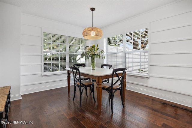 dining room with baseboards, a healthy amount of sunlight, dark wood finished floors, and crown molding