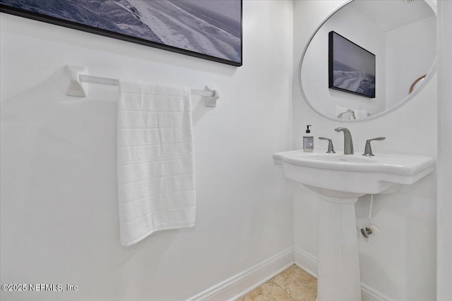 bathroom featuring tile patterned flooring and baseboards