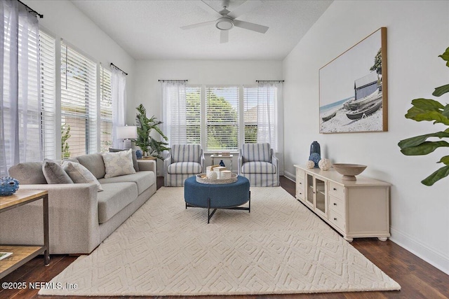 living room featuring a wealth of natural light, baseboards, wood finished floors, and a ceiling fan