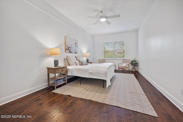 bedroom with a ceiling fan, baseboards, and wood-type flooring