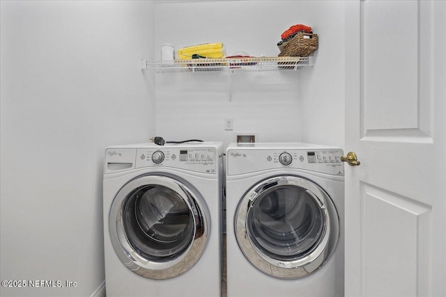 clothes washing area with separate washer and dryer and laundry area