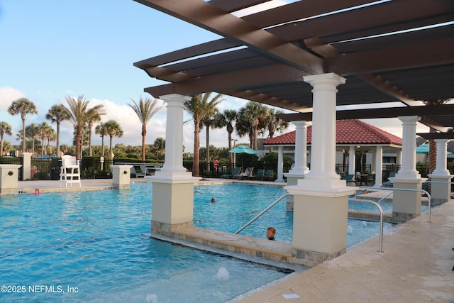 community pool with a patio and a pergola