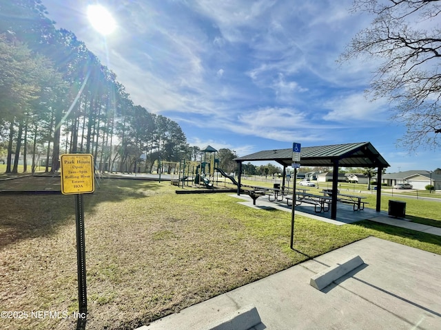 view of home's community featuring playground community and a yard