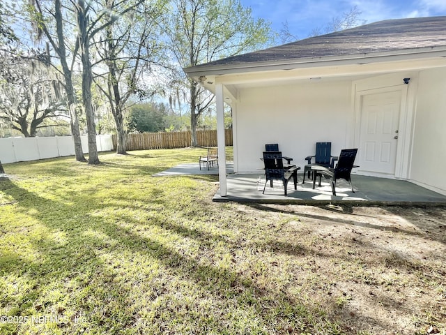 view of yard featuring fence and a patio area