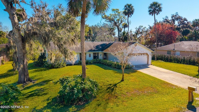 ranch-style home with concrete driveway, a garage, and a front yard