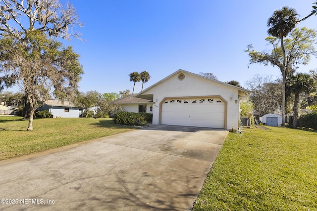 ranch-style house featuring a shed, concrete driveway, a front yard, a garage, and an outdoor structure