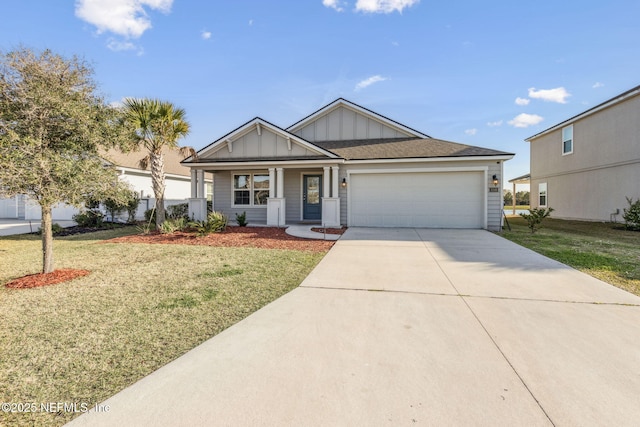 view of front of home with driveway, an attached garage, board and batten siding, and a front yard