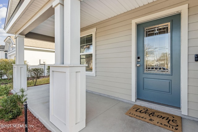 doorway to property featuring covered porch