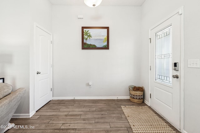 entryway featuring baseboards and wood finish floors