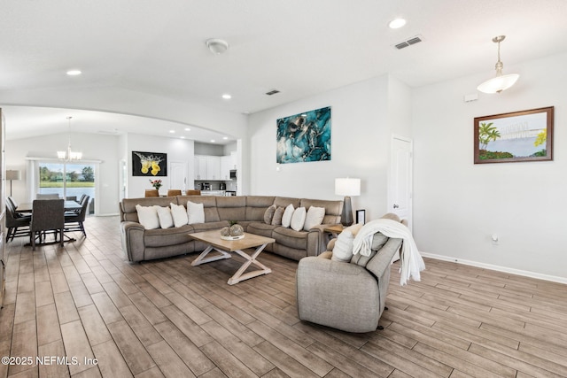 living area featuring visible vents, vaulted ceiling, recessed lighting, light wood-style floors, and an inviting chandelier