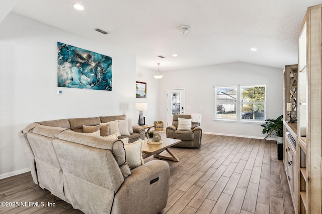 living area featuring recessed lighting, baseboards, lofted ceiling, and wood finished floors