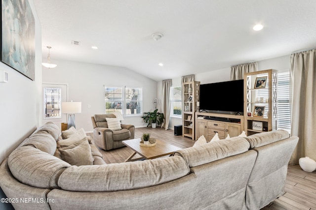 living room featuring visible vents, recessed lighting, lofted ceiling, and light wood-style floors