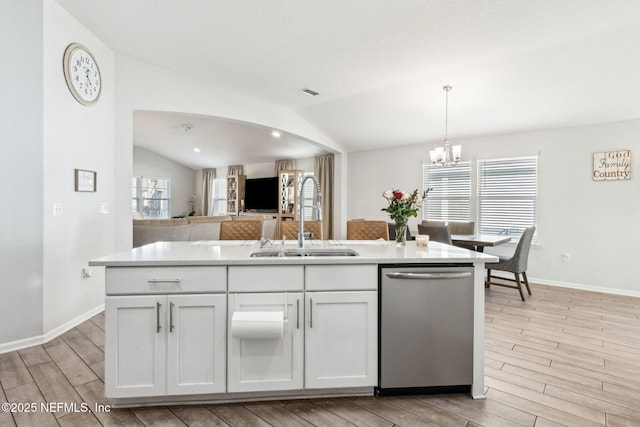 kitchen featuring a sink, lofted ceiling, dishwasher, and white cabinets